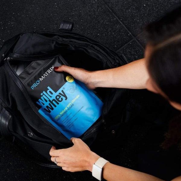WILD WHEY WHEY PROTEIN POWDERS 2kg VANILLA, Concentrate WILD WHEY. girl in gym taking wld whey packet out of gym bag